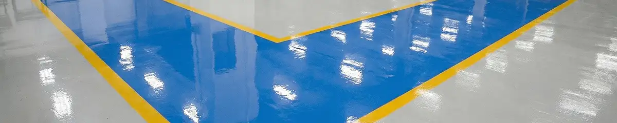 A factory floor professionally covered and marked with epoxy flooring in Lakewood, CO