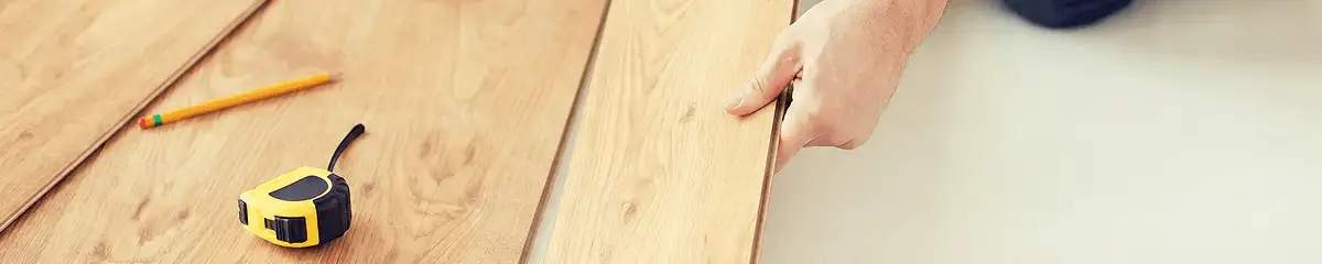 A professional installing wood flooring in Lakewood, CO