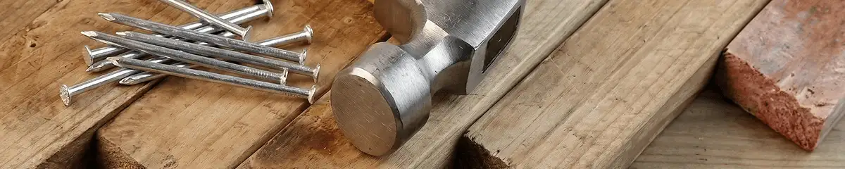 Hammer and nails on hardwood flooring boards in Lakewood, CO