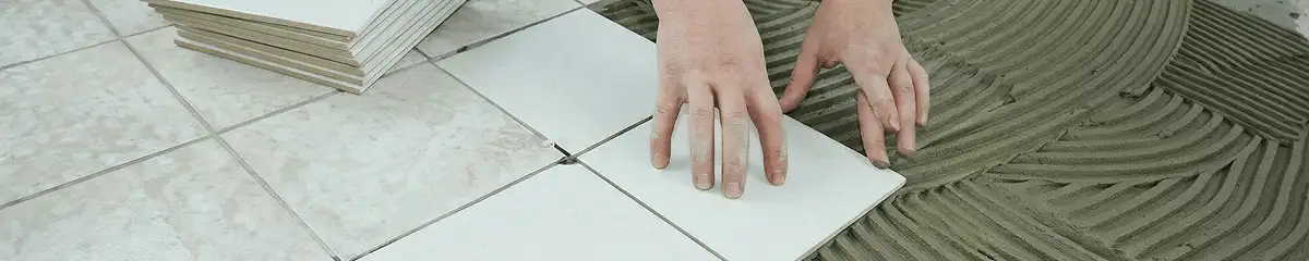 Professional installing white tile floors in Lakewood, CO