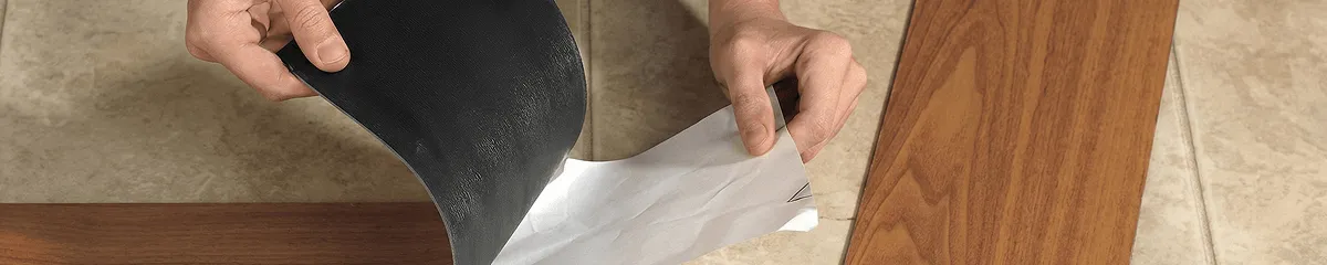 A professional installing vinyl flooring in Lakewood, CO