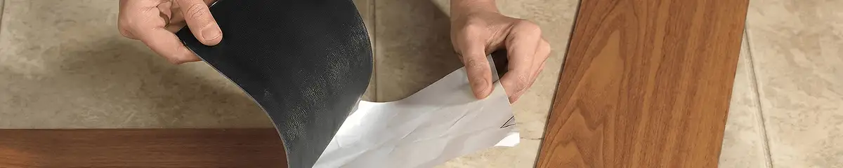A professional installing vinyl flooring in Lakewood, CO
