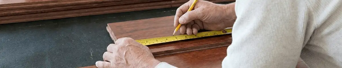 A professional installing wood flooring in Lakewood, CO
